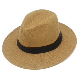 Top-down macro view of woven Panama straw hat with black decorative ribbon band