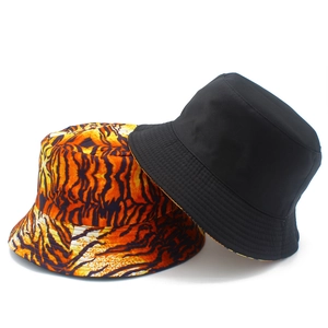 Double-sided bucket hat featuring classic black and trendy orange tiger print pattern