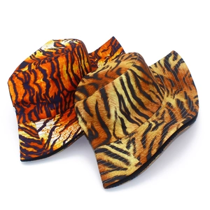 Detail of orange and brown tiger print bucket hats with neat stitching and canvas texture