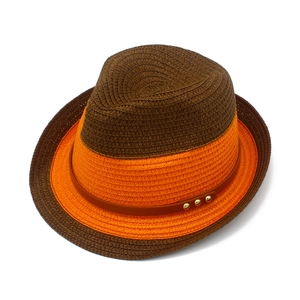 Detailed shot of two-tone contrast straw fedora with orange band and studded leather strap