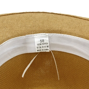 Detail of Panama straw hat interior showing 100% paper material label and sweatband
