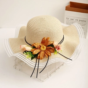 Beige straw sun hat with floral sunflower accents and white lace brim for beach vacations