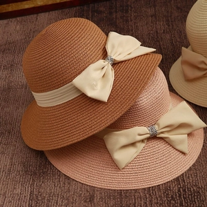 Elegant wide brim straw hats for women with satin ribbon bows and rhinestone accents