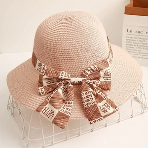 Elegant pink straw sun hat with printed ribbon bow for summer beach vacation style