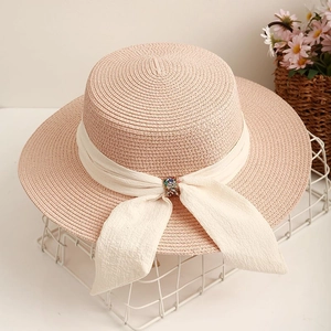 Flat top pink straw hat with white bow and rhinestone buckle for summer beach fashion