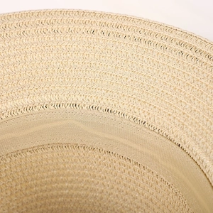 Macro detail showing natural straw weaving pattern and inner sweatband of the sun hat