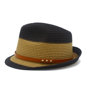 Detail of two-tone straw fedora with brown leather belt and golden metal rivets