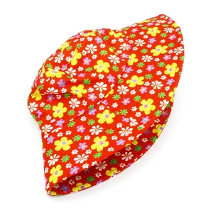 Dettaglio di cappello rosso con motivi floreali e tesa larga per protezione UV
