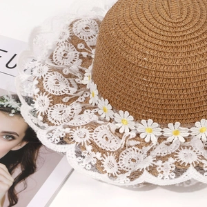 Woven straw sun hat with white lace trim and daisy floral details for summer beach style