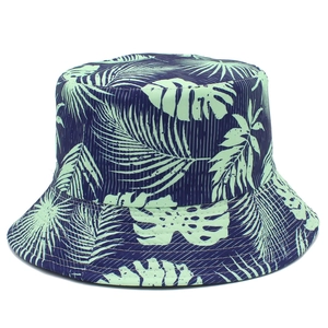Detailed view of tropical plant print on navy blue bucket hat with palm leaf pattern