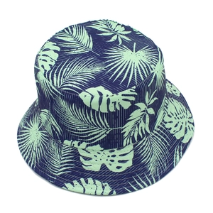 Detailed close-up of tropical palm leaf print on a navy blue cotton bucket hat