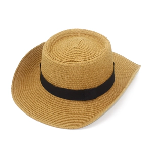 Top-down view of natural woven straw beach hat with black band and wide curved brim