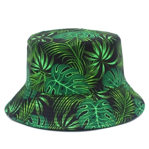 Double-sided sun bucket hat with tropical green leaf print on a black base for summer