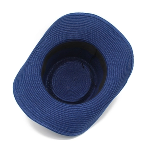 Detail of deep blue woven straw hat showing internal black sweatband and spiral weave