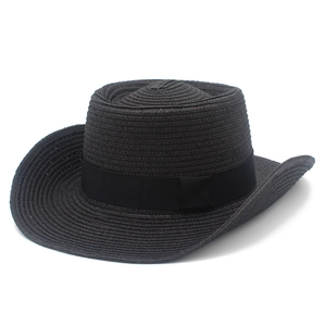 Detail of black straw cowboy hat featuring woven texture and tonal grosgrain ribbon