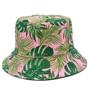 Pink reversible bucket hat with tropical palm leaf prints for sun protection in summer