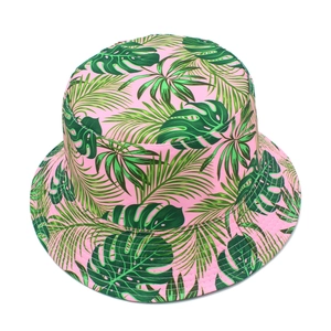 Detail of pink summer bucket hat showing tropical monstera and palm leaf print pattern