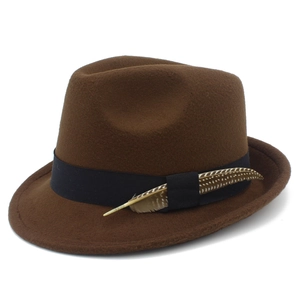 Detail of retro brown felt jazz hat featuring black grosgrain ribbon and natural feather