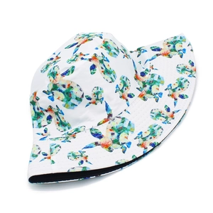 Close-up of a white bucket hat with colorful watercolor sea turtle patterns and cotton texture