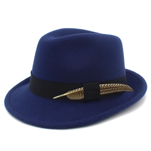 Detail view of navy wool felt fedora featuring black ribbon band and decorative feather
