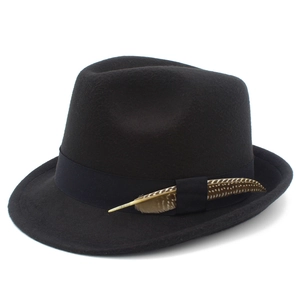 Detail of classic black felt fedora hat with grosgrain ribbon and natural spotted feather
