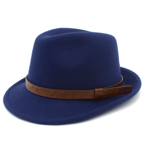Detail view of the brown leather band with embossed floral patterns on a dark blue fedora