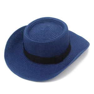 Detail showing the dense woven texture and black ribbon of this blue boater straw sun hat