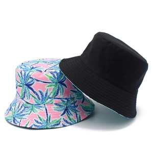 Double-sided bucket hat with black solid color and tropical palm tree prints for sun protection