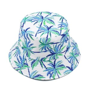Close-up of tropical palm tree pattern on a white cotton bucket hat for sun protection