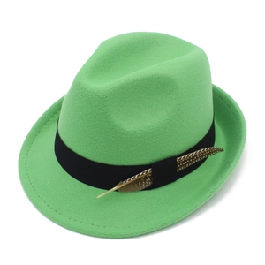 Detail of bright green felt fedora hat with black satin ribbon and natural feather accent
