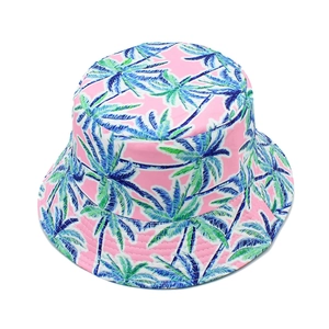 Macro detail of tropical palm tree print and stitching on pink reversible bucket hat