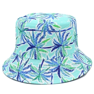 Close-up of tropical palm leaf print on light blue reversible bucket hat with stitch details