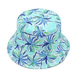 Close-up of a double-sided bucket hat with blue palm tree patterns on light blue fabric