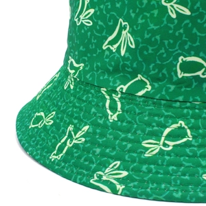 Detailed close-up of rabbit print and neat stitching on green cotton bucket hat fabric
