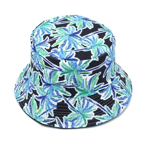 Close-up showing the blue and green palm leaf print on this black cotton bucket hat