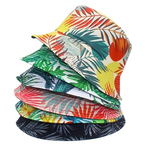 Vertical stack of six colorful foldable bucket hats with tropical leaf print on white background