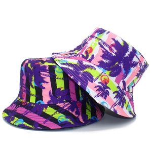 Close-up of tropical palm tree prints on neon striped bucket hats for summer beach vacations