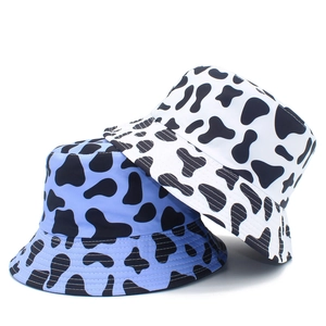 Two-pack cow print bucket hats in white and light blue with wide brim sun protection