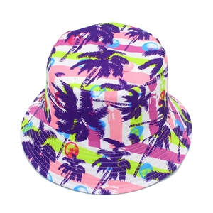 Close-up of tropical palm tree print and vibrant striped fabric on a summer bucket hat