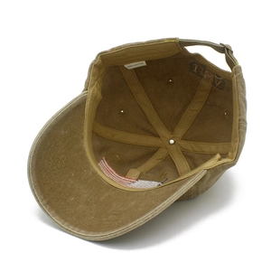 Detail view of the interior structure and cotton sweatband of a khaki baseball cap