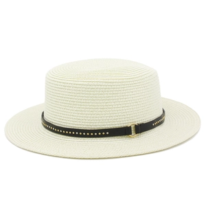 Detailed view of white straw boater hat featuring black leather band and metal studs