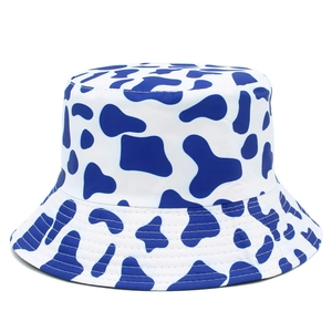 Detailed view of bucket hat with blue and white cow print and reinforced brim stitching