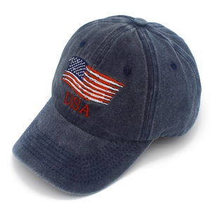 Detail of embroidered American flag and USA logo on navy blue washed cotton baseball cap