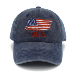 Detailed view of USA flag embroidery on washed navy cotton baseball sun hat