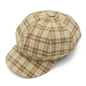 Détail de la casquette gavroche vintage à carreaux marron avec bouton et tissu cousu
