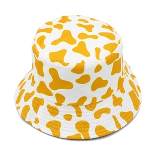 Detail shot of the white and yellow cow print canvas bucket hat with high-quality stitching
