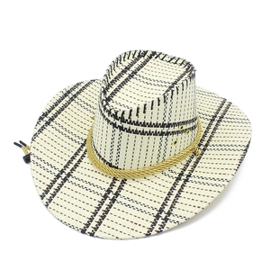 Detail of hand-woven straw cowboy hat with wide brim, yellow rope and windproof cord