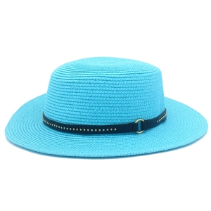 Close-up of bright blue straw sun hat featuring a black leather band with gold rivets