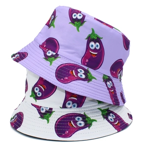 Detail of creative bucket hats with cute cartoon eggplant prints in purple and white