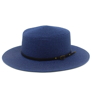 Detailed view of dark blue woven straw boater hat with black leather strap and gold buckle